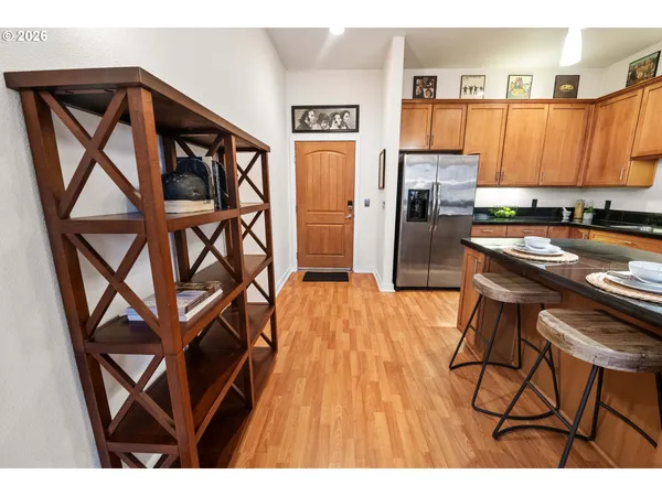 a open kitchen with a table chairs refrigerator and sink