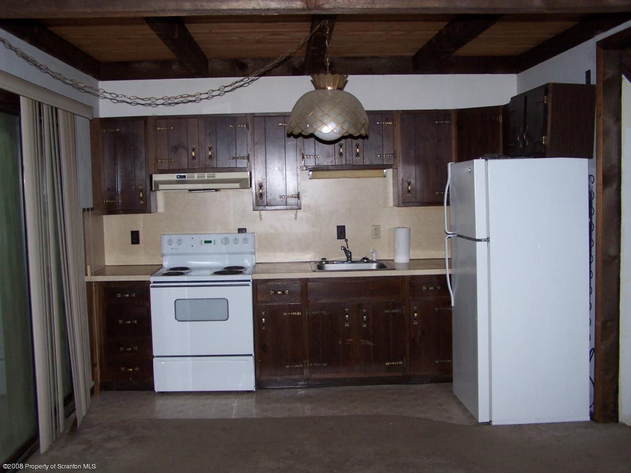 1282 Brookfield Road Lake Ariel, PA 18436 - Photo 2 of 5 a kitchen with stainless steel appliances granite countertop a refrigerator a sink and a stove