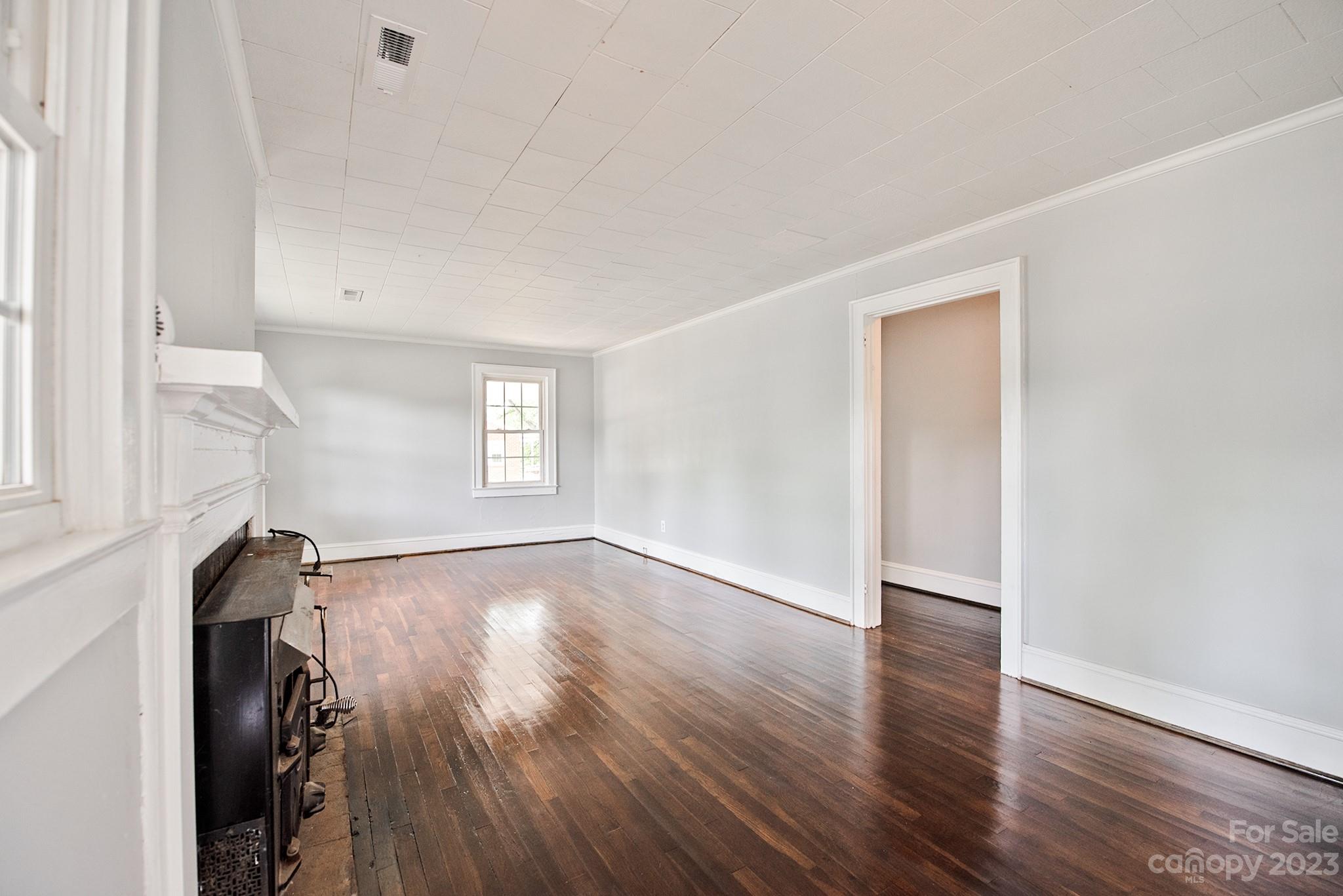 366 South Main Street Rutherfordton, NC 28139 - Photo 3 of 22 a view of an empty room with wooden floor and a window