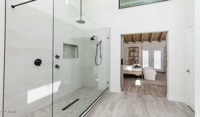 a bedroom with a bed a couch and a window