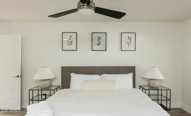 a bedroom with a bed and wooden floor