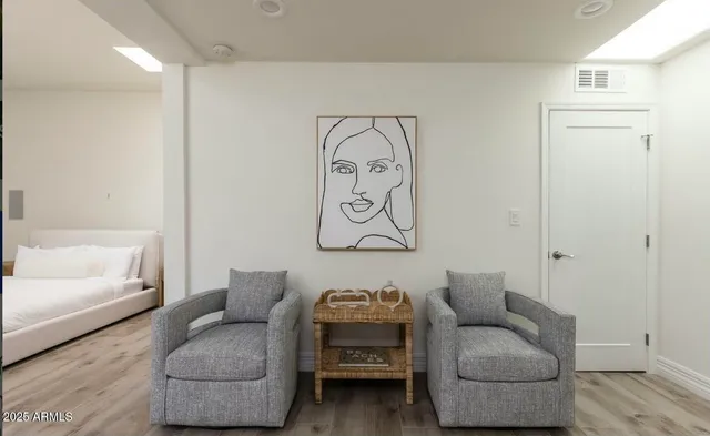 a view of swimming pool with seating area and trees in the background