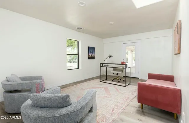 a backyard of a house with a yard and outdoor seating