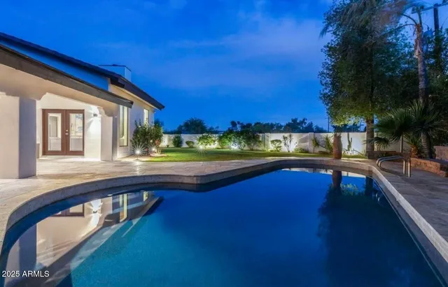 a view of a house with backyard and sitting area