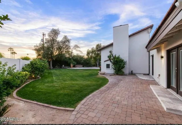 an aerial view of a house with a yard basket ball court and outdoor seating