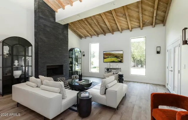 a kitchen with stainless steel appliances a sink a stove a refrigerator cabinets and a dining table