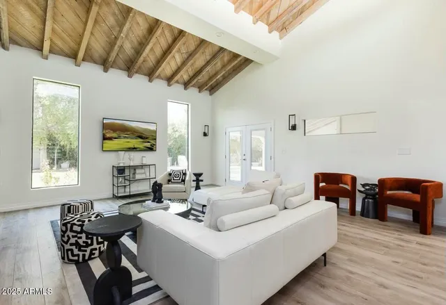 a living room with furniture and wooden floor