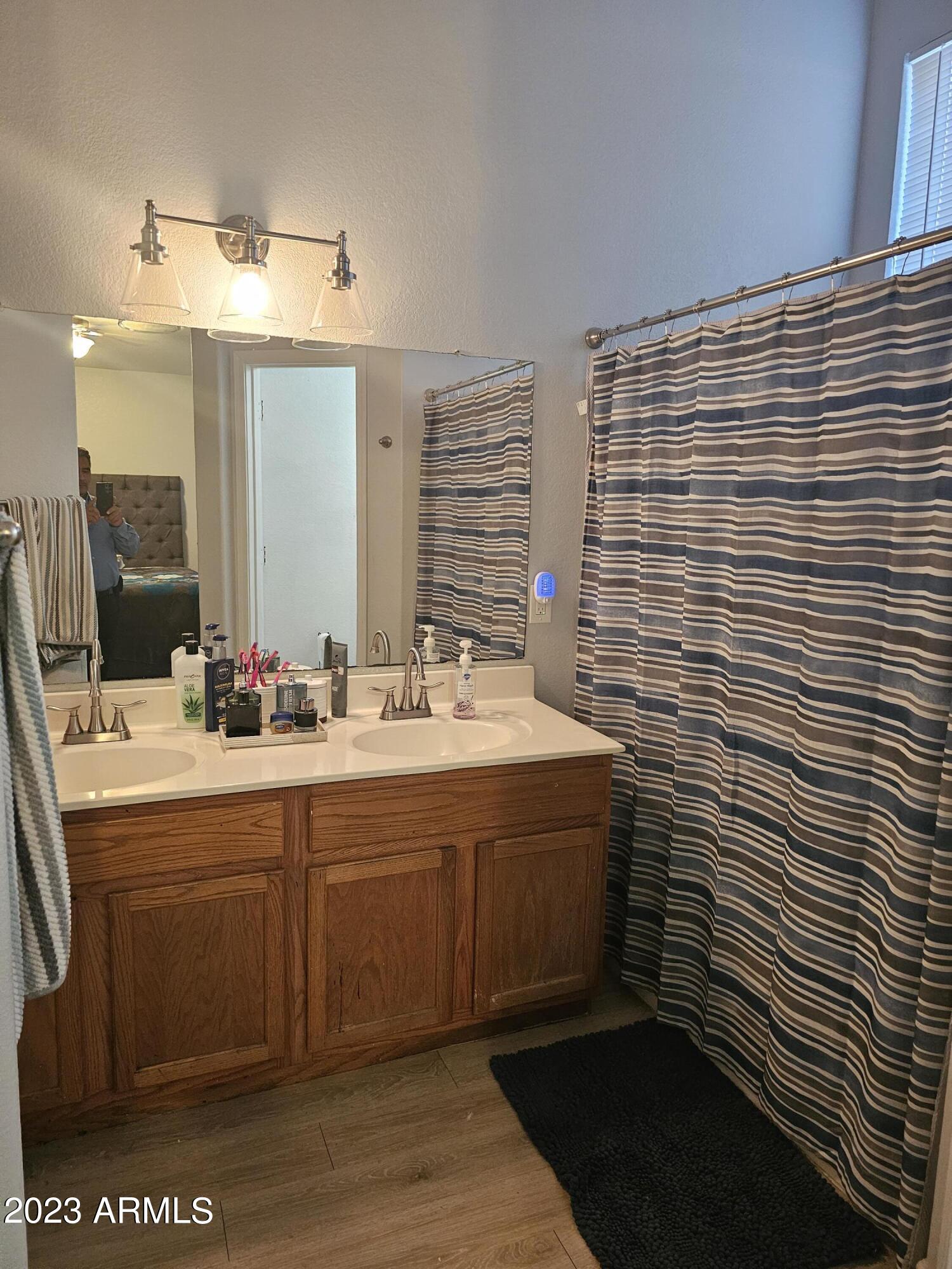 8738 West Granada Road Phoenix, AZ 85037 - Photo 5 of 13 a bathroom with a sink and a mirror
