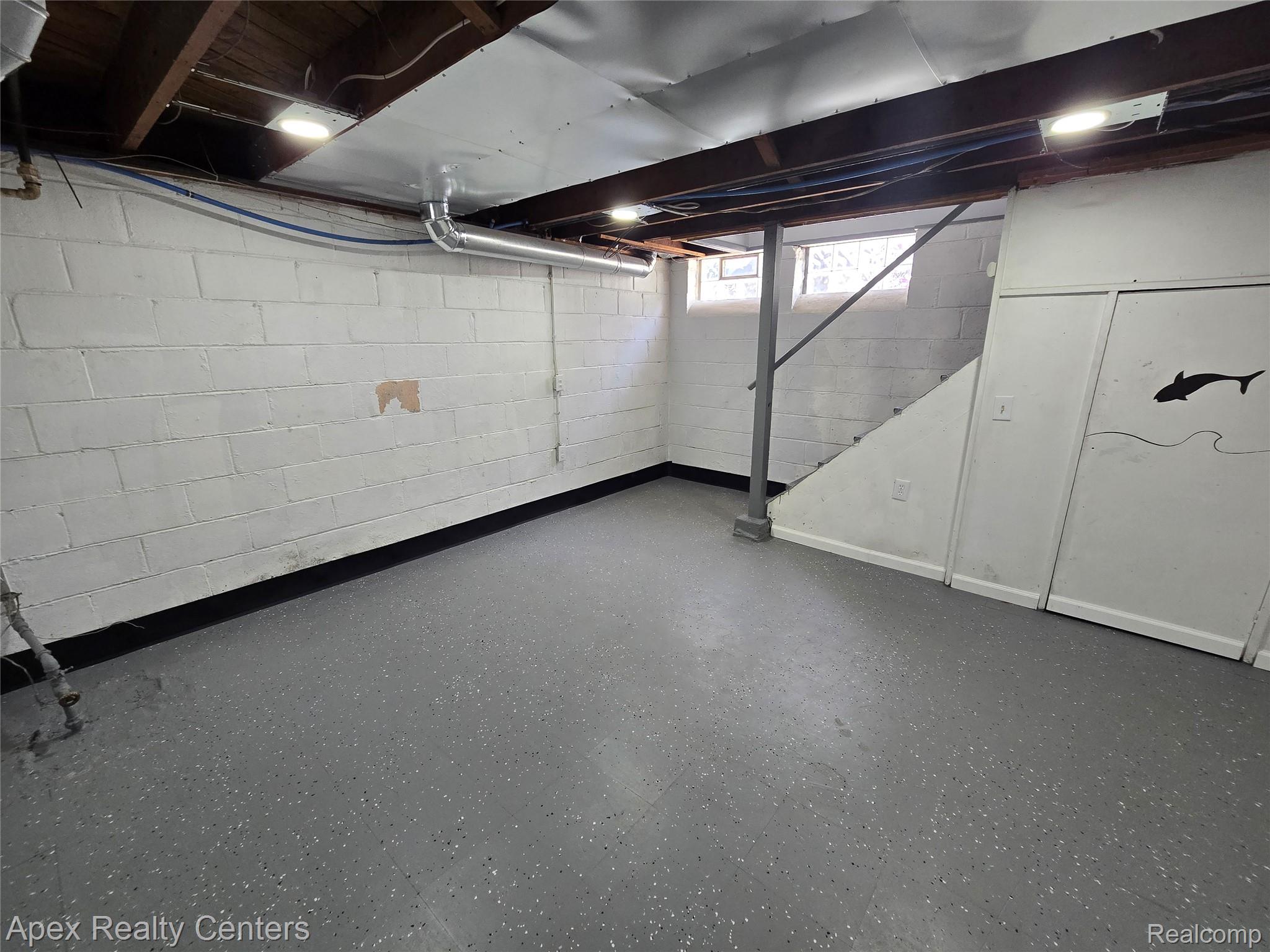 7671-7675 Evergreen Road Detroit, MI 48228 - Photo 50 of 84 7671 Evergreen. Basement space featuring painted cinder block walls, exposed wood ceiling joists, and overhead lighting