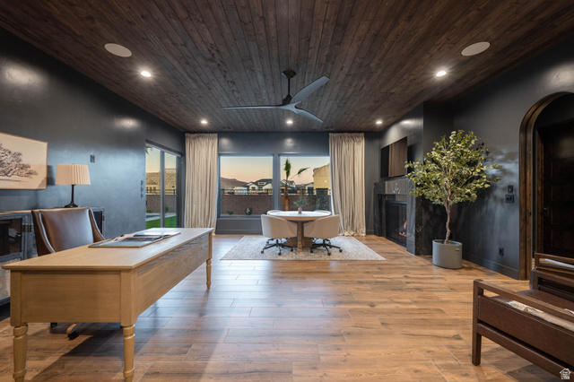 4871 South Homestead Way Washington, UT 84780 - Photo 55 of 151 Home office featuring a lit fireplace, ceiling fan, arched walkways, light wood finished floors, and wooden ceiling