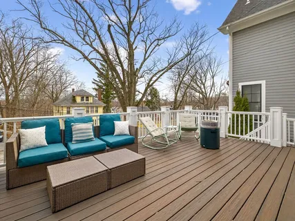 a view of a deck with couches floor to ceiling window with wooden floor