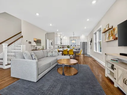 a living room with furniture and a wooden floor