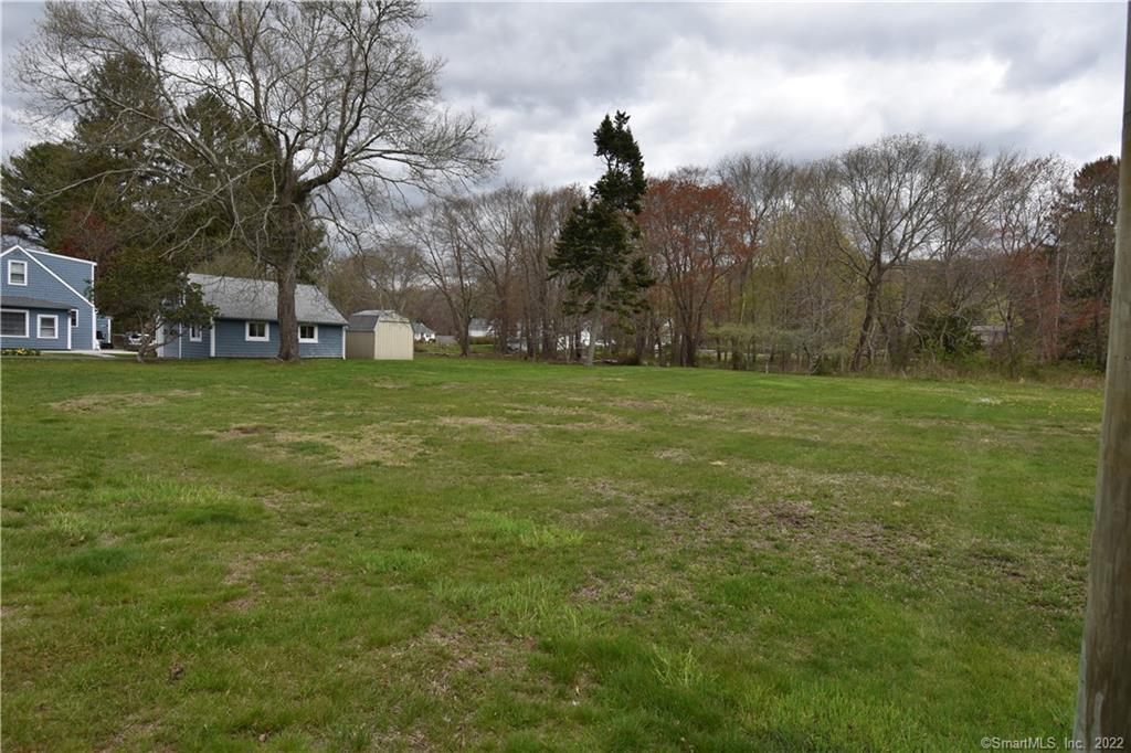 215 Pequotsepos Road Stonington, CT 06355 - Photo 5 of 5 a big yard with lots of green space and house in the back