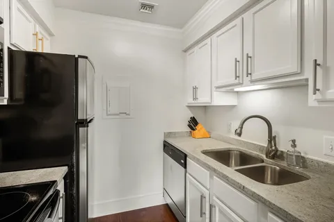 a kitchen with stainless steel appliances granite countertop a refrigerator sink and cabinets