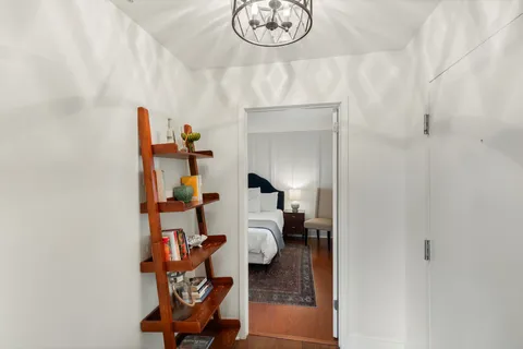 a living room with furniture and a painting on the wall