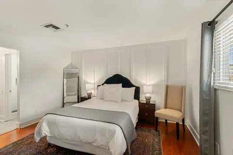 a bedroom with a bed and wooden floor