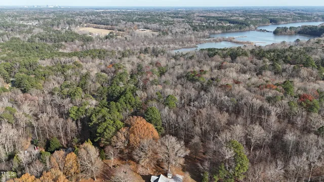 an aerial view of house with yard and mountain in the background