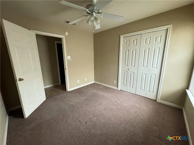 an empty room with windows and entrance
