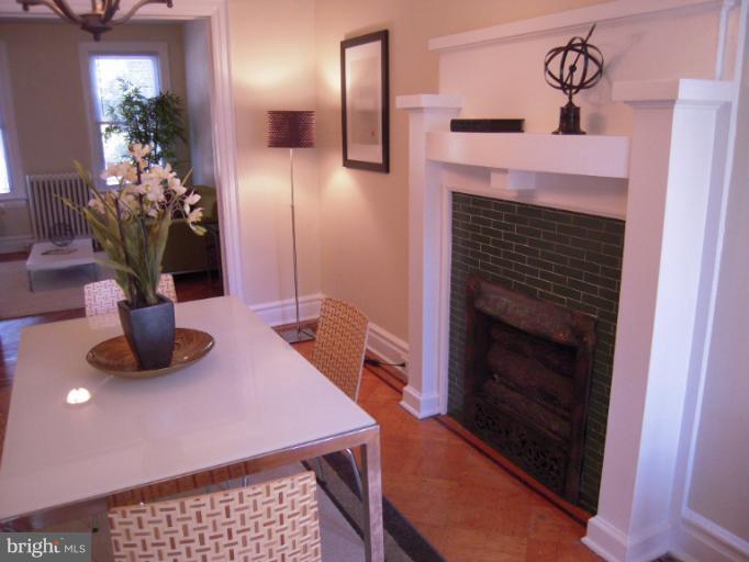 1346 Spring Road Northwest Washington, DC 20010 - Photo 2 of 30 a dining room with furniture and a fireplace