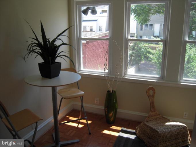 1346 Spring Road Northwest Washington, DC 20010 - Photo 17 of 30 a view of a workspace with furniture and a window
