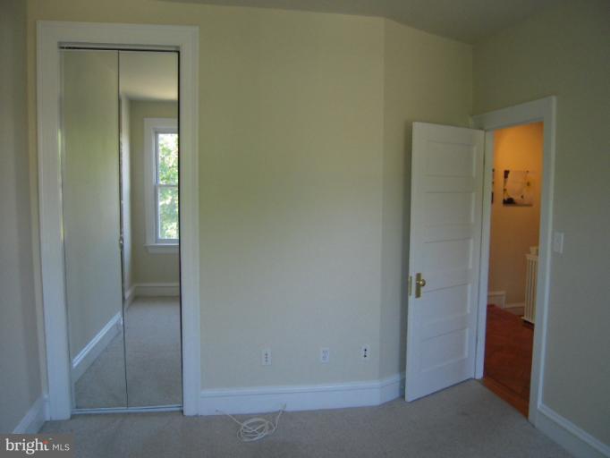 1346 Spring Road Northwest Washington, DC 20010 - Photo 19 of 30 a view of an empty room with closet and mirror