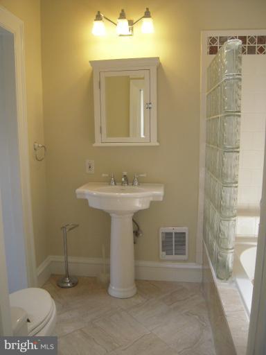 1346 Spring Road Northwest Washington, DC 20010 - Photo 21 of 30 a bathroom with a sink a toilet and shower