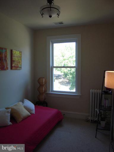 1346 Spring Road Northwest Washington, DC 20010 - Photo 7 of 30 a bed room with a bed and a window
