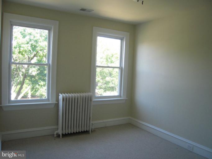 1346 Spring Road Northwest Washington, DC 20010 - Photo 8 of 30 an empty room with a window