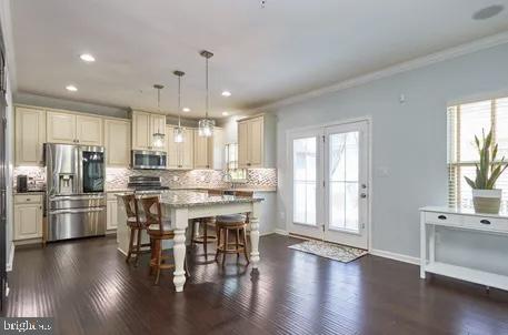 2301 Harmsworth Drive Dumfries, VA 22026 - Photo 5 of 18 a kitchen with stainless steel appliances a dining table chairs stove and refrigerator