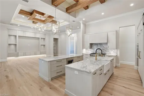 a large kitchen with kitchen island a sink stainless steel appliances and cabinets