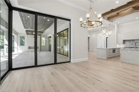 a view of a kitchen with furniture and wooden floor