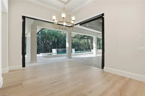 a view of a kitchen with wooden floor and a refrigerator