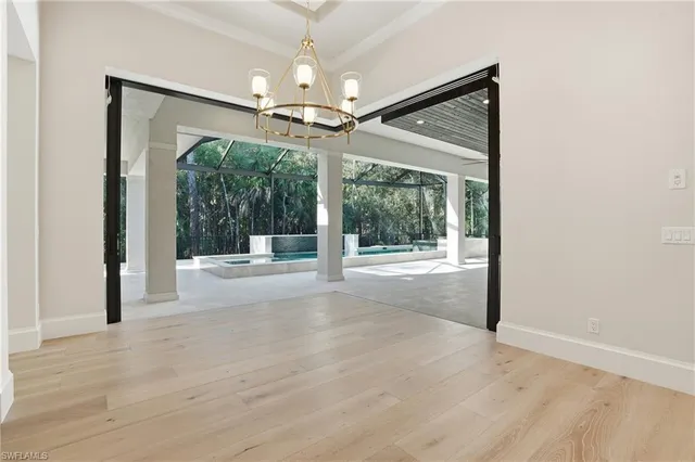 a view of a kitchen with wooden floor and a refrigerator
