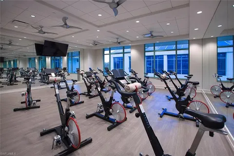 a view of a room with lots of wooden furniture and a projector