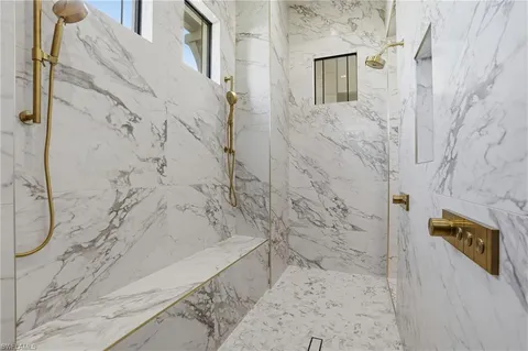 a bathroom with a white toilet and a shower