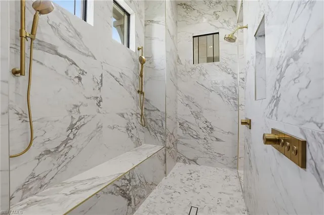 a bathroom with a white toilet and a shower