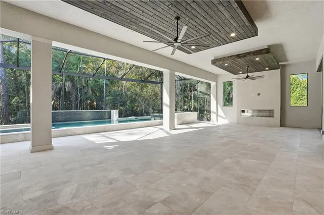 a view of a livingroom with furniture and floor to ceiling window
