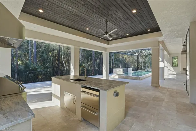 a large white kitchen with a large window