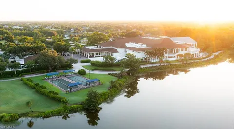 an aerial view of residential houses with outdoor space and river