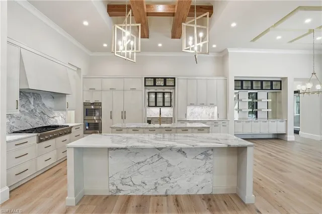 a kitchen with kitchen island granite countertop a stove and a wooden floors