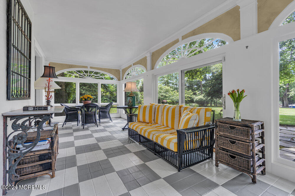 16 Buttonwood Lane Rumson, NJ 07760 - Photo 13 of 48 a living room with furniture a rug and a chandelier