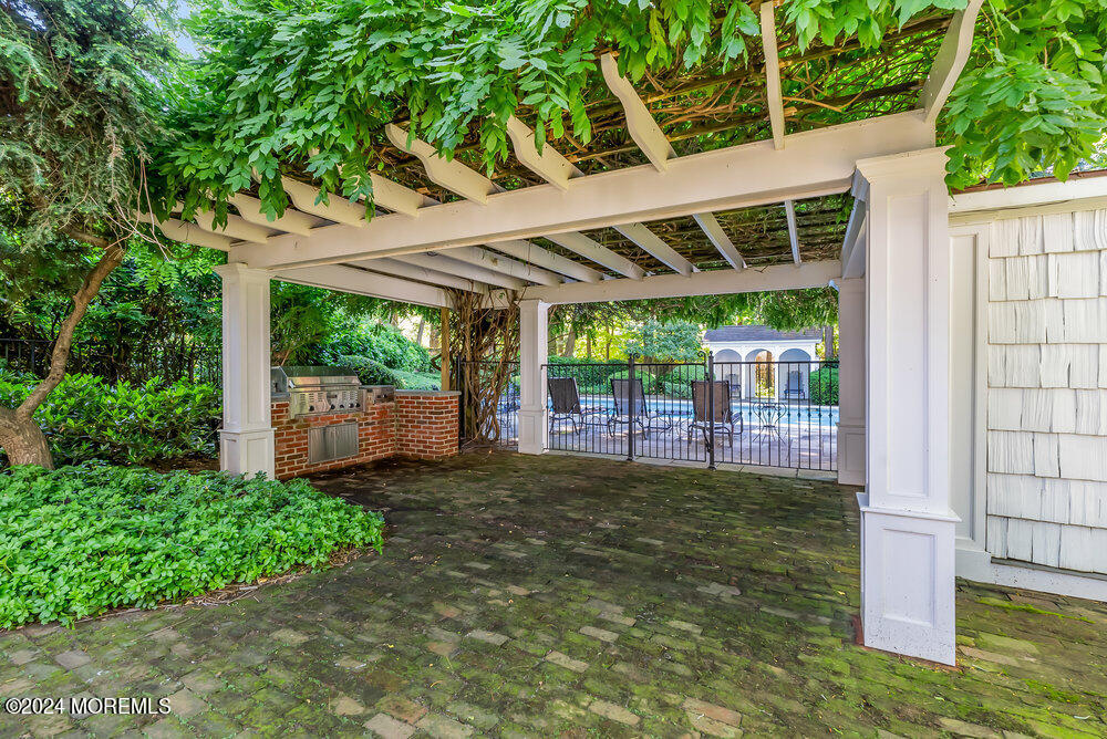16 Buttonwood Lane Rumson, NJ 07760 - Photo 25 of 48 a view of a backyard with large trees and plants