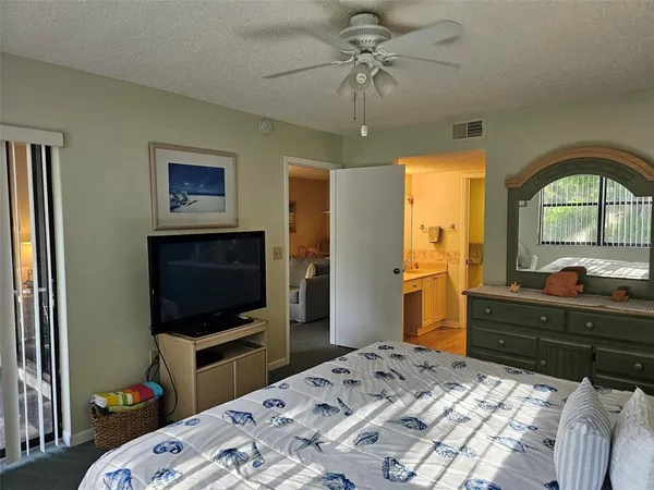 a bedroom with a bed and a tv