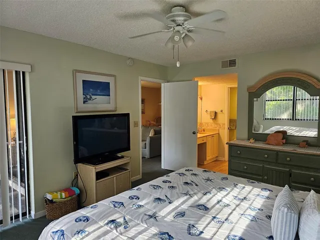 a bedroom with a bed and a tv