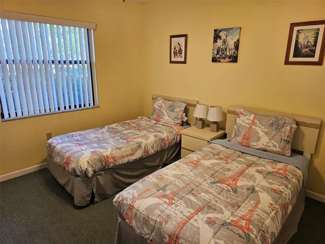 a bedroom with a bed and wall painting