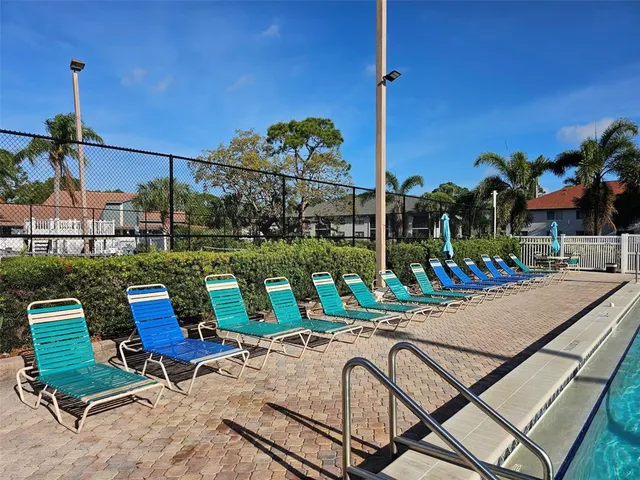 a view of a house with backyard and trees