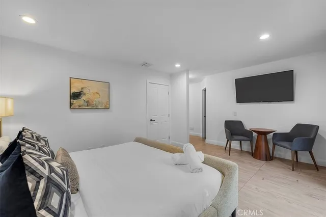 a bedroom with a bed and a chair