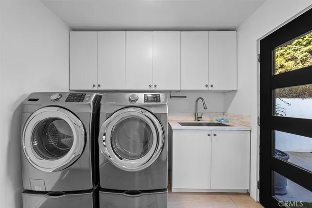 a utility room with sink dryer and washer