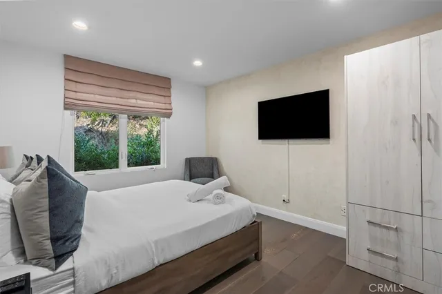 a bedroom with a bed and a flat screen tv