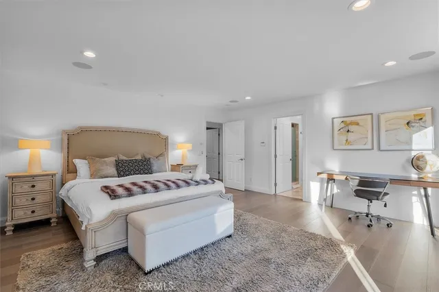 a bedroom with a bed a table and chair